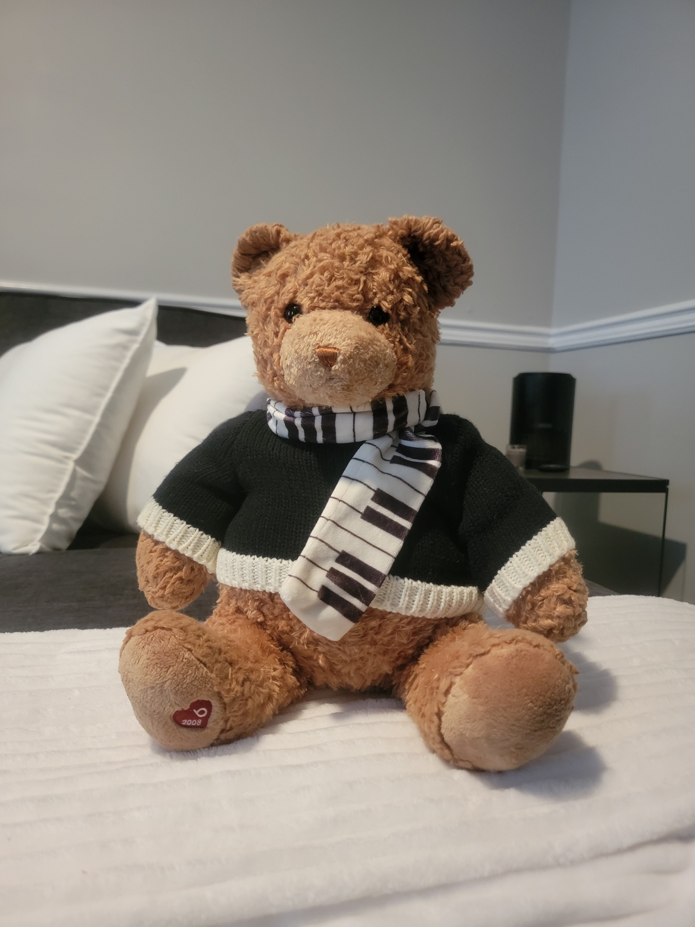 Plush Brown Teddy Bear with Black Sweater and Striped Piano Scarf